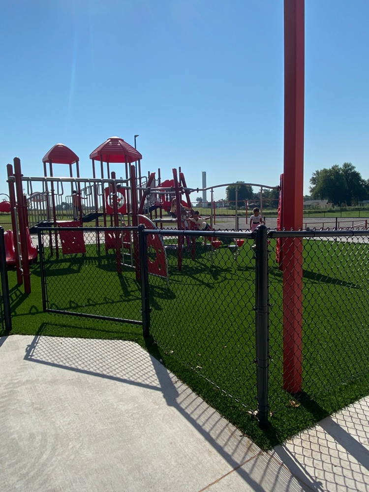 playground equipment and swings in the back 